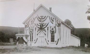 West Milford Town Hall (now the West Milford Museum) is seen in 1934. The monument in front of the building, no longer there, contained the names of residents who served in World War I. The township was celebrating its 100th anniversary.