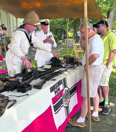 Visitors look at old weapons.