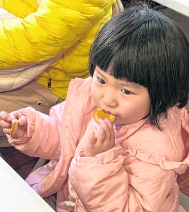 Grace Yu, 3 of Boonton tests maple syrup on a cookie.