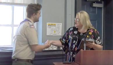 West Milford Mayor Michele Dale honors Eagle Scout Sean Earl Partington.