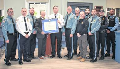 Representatives of the West Milford Police Departmentwere on hand to accept the New Jersey Association of Chiefs of Police accreditation designation during the Town Hall meeting on Wednesday, Nov. 12. Holding the official Accreditation Certificate are (center, left to right) Association Program Director, Harry Delgado, and WMPD Chief Shannon Sommerville.