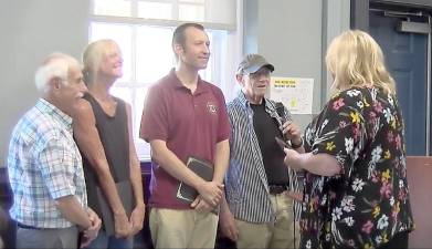 Robert Nicholson and other West Milford Television Commission members present their Channel 77 first place award plaque, presented to them by the Jersey Access Group, to Mayor Michele Dale.