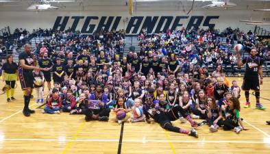 Members of the Harlem Wizards pose with a team of West Milford teachers and children during a fundraising game Saturday, March 18. (Photos by Rich Adamonis)