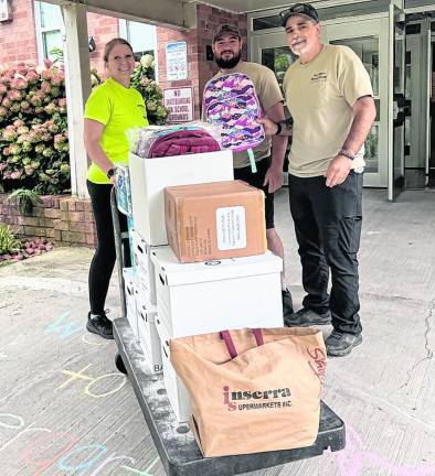 Members of the West Milford First Aid Squad pose with school supplies.