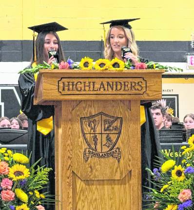 Ava Brock, senior class communications liaison; and Sarah Wardlaw at the podium.