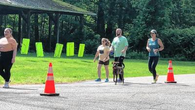 Participants in the sixth annual Scott’s Fun Run on Sunday, May 19 walk and run along the road to the West Milford Recreation Center. (Photo by Kathy Shwiff)