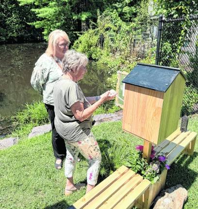 Karen Thompson shows the wind phone to West Milford Mayor Michele Dale.
