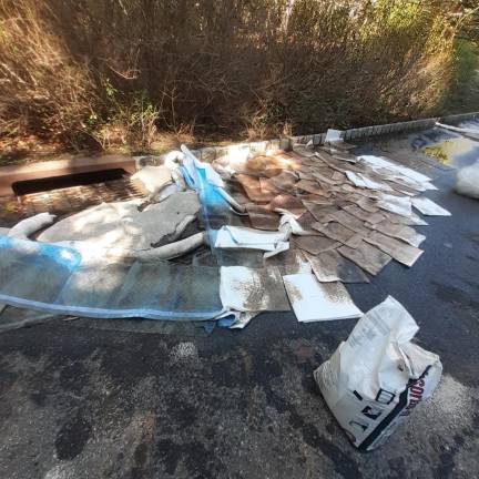 Absorbent pads are used to soak up home-heating oil that spilled after a truck crash on Greenwood Lake Turnpike in Hewitt
