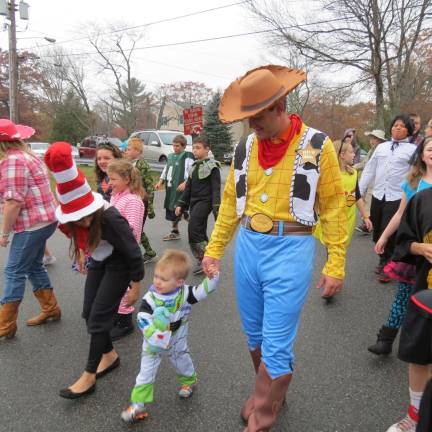 Photos by Patricia Keller Fourth grade teacher Brian Leslie went classic as Woody with his two-year-old son Bryce as Buzz Lightyear.