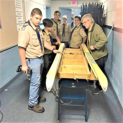 Boy scout Troop 114 revamp a sled for the upcoming Klondike Derby.