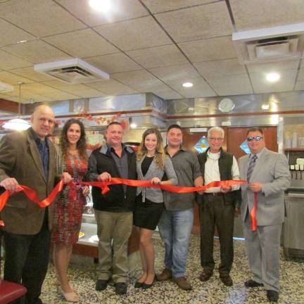 Photo by ANN GENADER The new owner/operator of the diner is Eric Blasone with his Sit n&#x2019; Chat Diner and Family Restaurant. At the ribbon cutting on Nov. 19 are from left are West Milford Chamber of Commerce representative Andy Abdul, West Milford Mayor Bettina Bieri, Blasone and his family and friends.
