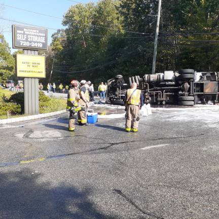 Crews work to clean up after a home-heating oil spill on Greenwood Lake Turnpike on Friday. The overtime truck hit a telephone pole and overturned.