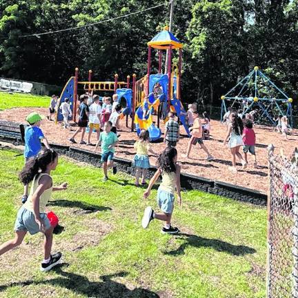 Children rush the playground after the ribbon cutting.