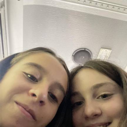 Ava and Siena snap a selfie on the bus en route to sixth grade.