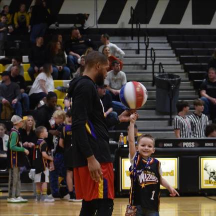 Austin Mele, 5, shows the crowd his basketball-spinning skills.
