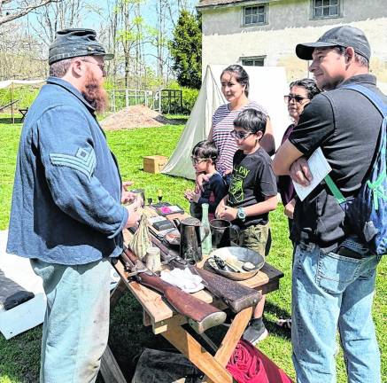 A family gets a look at a Civil War era firearm.