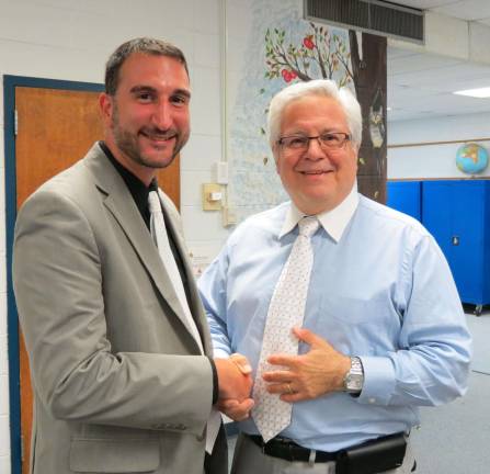 Photos by Patricia Keller Newly hired Upper Greenwood Lake Principal Steven Deo, left, is congratulated by interim Superintendent Anthony Riscica at the West Milford Board of Education special meeting, held on Aug. 13.