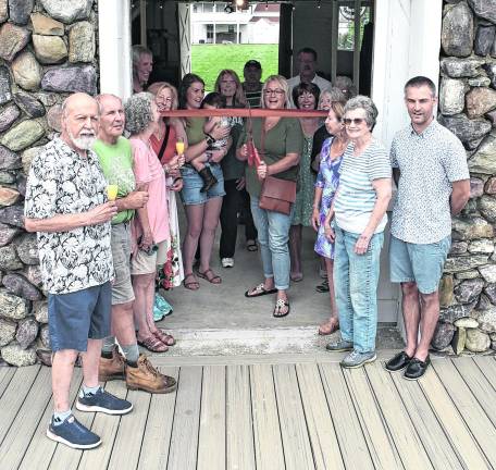 Wallisch Homestead board members and friends join Mayor Michele Dale, center, for the ribbon cutting for an expansive new 20’ x 40’ Trex deck that now stands at its historic barn.