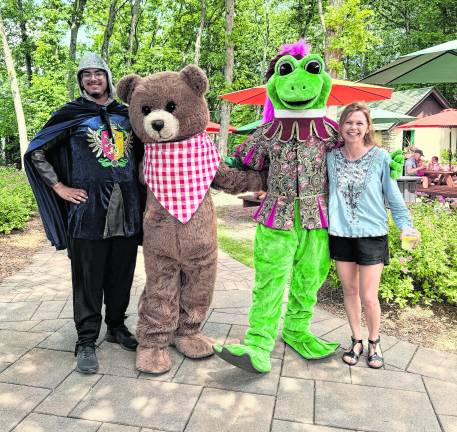 Christine Vander Ploeg poses with three characters.