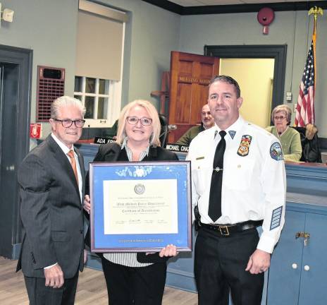 Harry Delgado, Program Director, New Jersey State Association of Chiefs of Police, presents West Milford Mayor Michele Dale and Police Chief Shannon Sommerville with a certificate commemorating the Township’s state accreditation, a first for West Milford during the Town Hall meeting on Wednesday, Nov. 12.