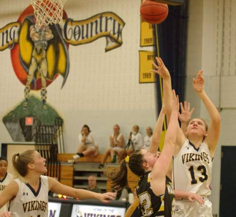 Vernon's Alicja Wesloske (13) releases the ball during a shot in the fourth quarter. Wesloske scored four points and grabbed seven rebounds.