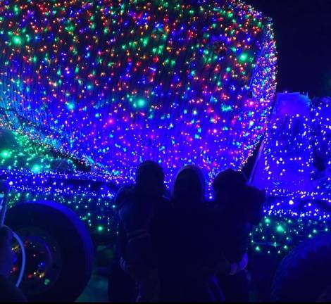 Mesmerized by the thousands of lights on the Salomone concrete truck are Gemma Saum, Brayden Konz, and Brantley Link.