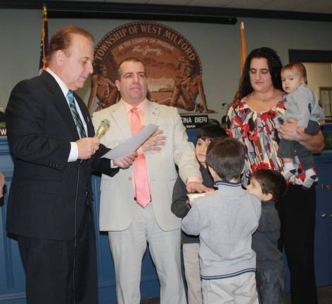 Councilman Lou Signorino takes his oath of office Wednesday night,, beginning his third term as West Milford Councilman. His family, including his wife, Melissa, and four sons - Salvatore, Joseph, Luciano and Sebastian, held the Bible. State Sen. Joseph Pennacchio, left, did the honors.