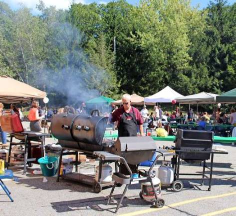 Photos by Ginny Raue George Miller mans the grill at the St. Joseph parish picnic on Sept. 7. Friends, family and fellow parishioners packed the church property in a celebration of the parish's 250th anniversary. , the aroma of hot dogs and hamburgers on the grill, a table full of picnic foods, games for adults and kids, all under a beautiful late summer sky. A day of celebration and fun as the parish advances through its 250th year in the town. Here.