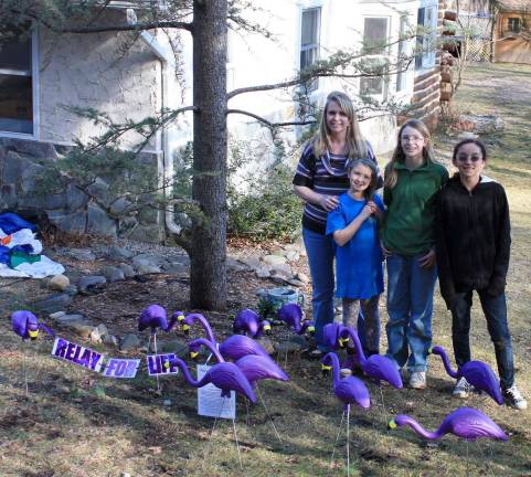 Photo by Ginny Raue West Milford's MacArthur family enjoyed the surprise visit from the Relay for Life purple flamingos. After making a donation to the cancer-fighting event Ms. MacArthur sent the birds on to a friend's house. &quot;I think this is great,&quot; she said. Watch out - you may get &quot;flocked&quot; too.