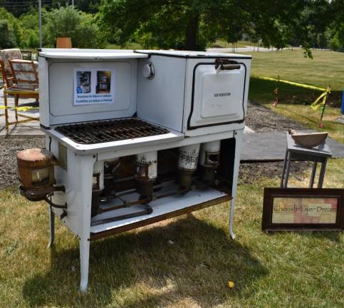 An antique porcelain and iron cooking stove was for sale.