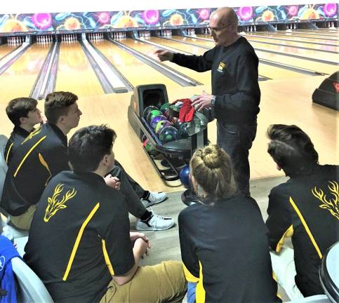 Submitted photos Coach Caillie conferences with the team before the quarterfinals match in Lodi Jan. 5.