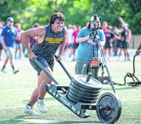 David Van Tassel does a wheelbarrow workout.