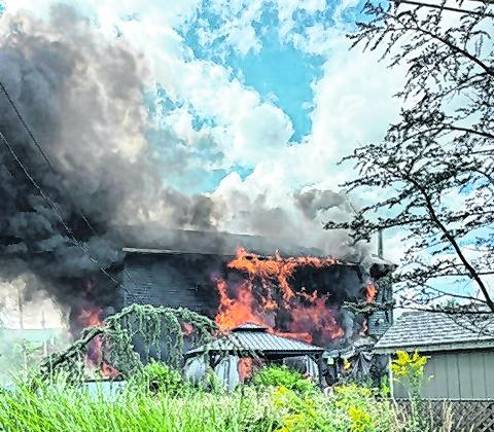 A structure fire burns at 2 Louis Ave.