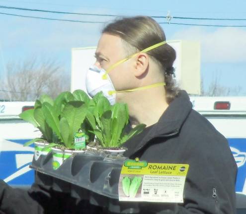 People wear face masks while shopping earlier this week in West Milford. Some of the shelves were bare at the local Dollar General Store.