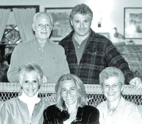R. Peter Straus and his family. From left to right, beginning in the back row, are: R. Peter Straus and son Eric Straus; and seated, from left: Diane Straus Tucker, Kate Straus, Jeanne Straus (president of Straus News).
