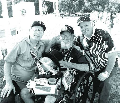 Mike Trochan, left, and brother Tom, far right, flank disabled vet and friend Al, center.