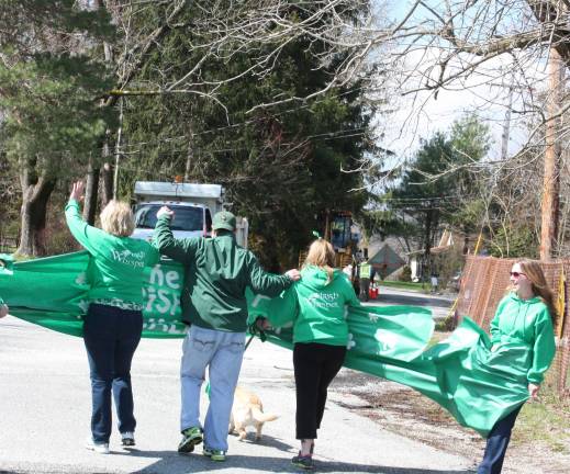 Photos by Ginny Raue The Kane family break the &quot;ribbon&quot; to kick off the walk around Pinecliff Lake. The event suceeded in raising $38,000. for the Lymphoma Research Foundation.