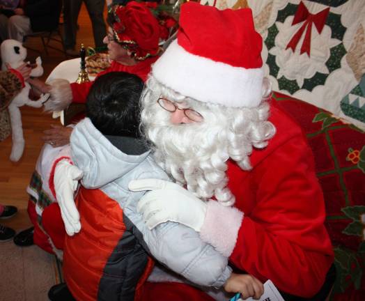Salvatore Signorino gave Santa an impulsive hug on his way out the door with his mom and brothers.