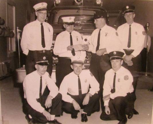 Photo by Ann Genader Back in 1965, a group of West Milford Company 6 firemen are seen with truck 604 when it was put into service. From left standing are Frank Decker Jr., George Day, Jim Finn and Ed Wink. Kneeling are Jimmy Pulis, Adrian Birdsall and Joe Weiss. Fire Company 6 is looking for volunteers. Stop by on Ridge Road on Monday evenings at 7 to check it out.