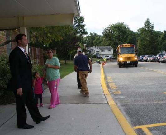 Principal Daniel Novak waited outside of Upper Greenwood Lake Elementary School Wednesday morning as the buses rolled in.