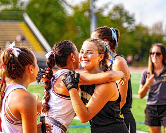 Senior Addy Seidner greets a Pompton Lakes player before the game.