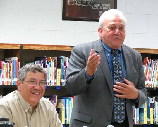 West Milford School Board President Dave Richards chuckles as Interim Superintendent John Petrelli addresses the board of education and audience members. Tuesday was Petrelli's last meeting as he moves on to another district next week.