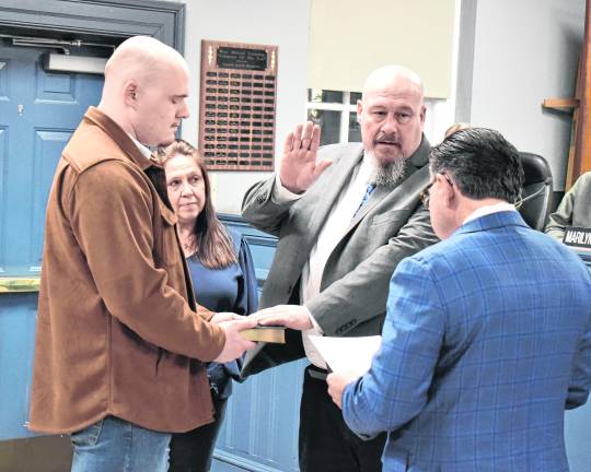 Senator Anthony Bucco (LD-25) swears in Councilman Kevin Goodsir to his third term on the West Milford Township Council as his wife and son look on.