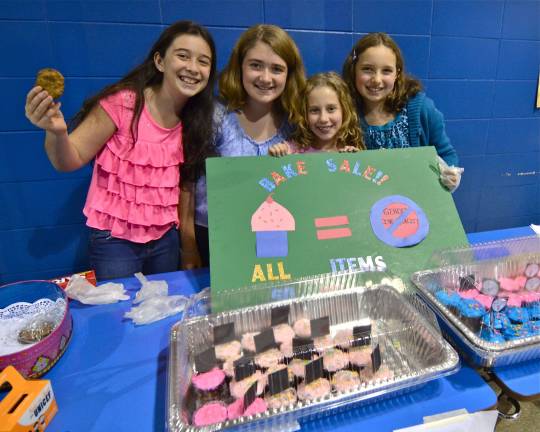 Project Night included a bake sale whose proceeds went to UNICEF. Pictured from left are Jessica Brigante, Kylie Montena, Amanda Gerold, and Riley Knight.
