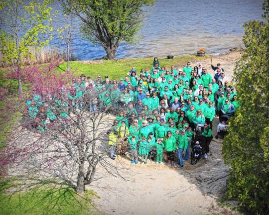 Participants in the Irish Whisper Walk of Hope pose for a photo in the shape of a shamrock by Pinecliff Lake. (Photo by Mike Dygos)