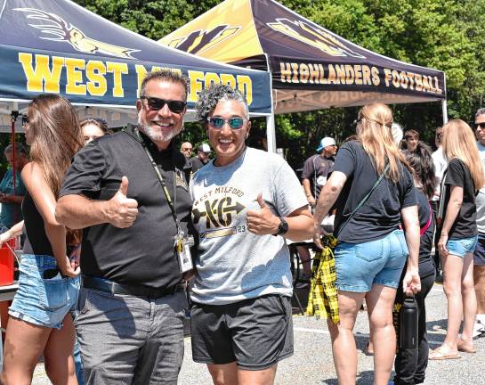 Athletic director Joe Trentacosta with Andrea Jones, head coach of the girls cross country team, at the tailgate and watch party Sunday.