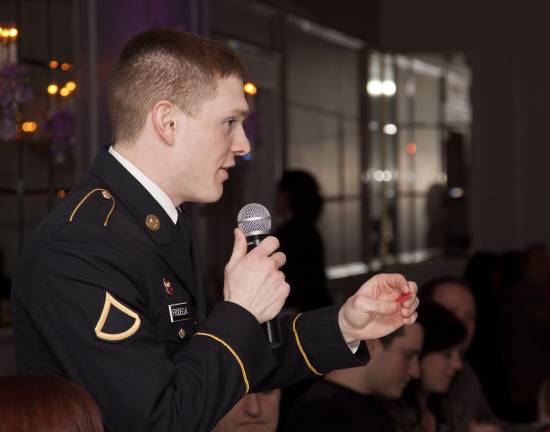 US Army Reservist PFC Thomas Frodella Jr. announces the winning raffle ticket.