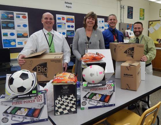 Macopin Assistant Principal Matt Strianse, Principal Mary Reinhold, Business teacher Rich Dygos and Assistant Principal Marc Citro get the boxes ready from Macopin Middle School.