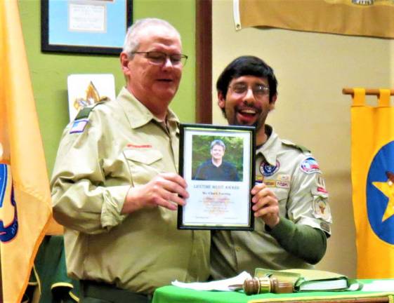 Patricia Keller photo Chuck Enering, left, is presented with the &quot;Lifetime Merit Award&quot; recognition from West Milford Boy Scout Troop 44 by Scoutmaster William Cytowicz at the Court of Honor Ceremony on Dec. 16.