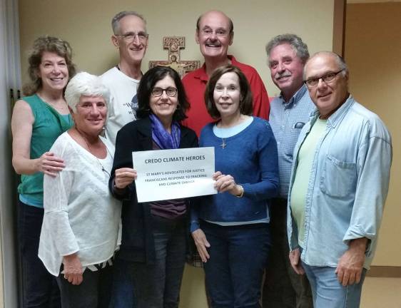 Photo provided A few members of the St. Mary’s Advocates for Justice and Franciscan Response to Fracking and Climate Change Ministries show their pleasure at receiving recognition and a $500 grant from CREDO Action, a national organization that supports groups that focus on social justice issues. Shown from left are, front row, Norma Stehle, Renee Allessio, Camille Gaines, and Mike Moffa. Back row, from left, Jackie Schramm, Charlie Nunzio, Norbert Langer, and Karl Stehle. Allessio and the Stehles are board members of Sustainable West Milford.